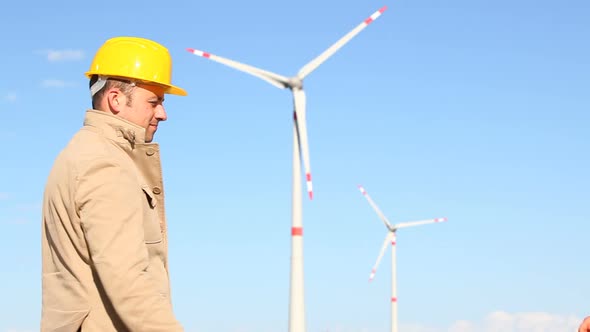 Engineers giving Handshake in Wind Turbine Power Station