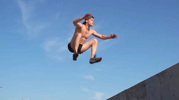 Fitness Man Jumping Exercising Outdoors.