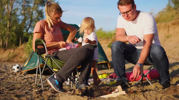 Spouses with Kid Prepare the Pastille on Fire the Dad Fries a Dessert on Skewer