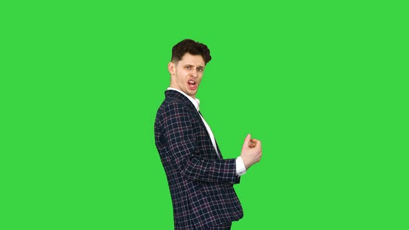 Cool Attractive Businessman Does Different Defiant Gestures on a Green Screen, Chroma Key.