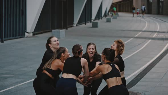 Young Happy and Active Female Sportswomen Doing a Group Handshake After Completing a Training