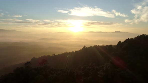 Aerial view Drone flying through the fog above mountain peak