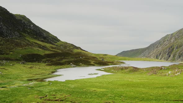 Stunning natural mountain landscape scenery of Cwm Idwal Lake in Glyderau range of Snowdonia, pan ri