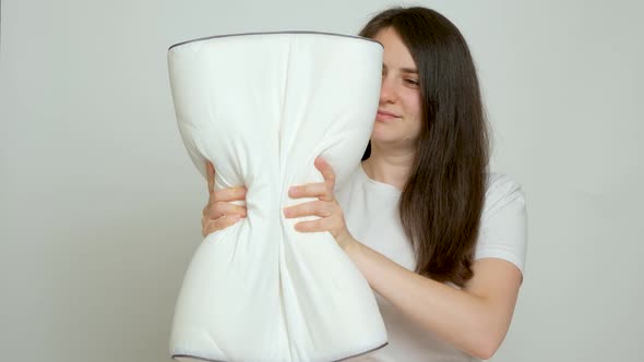 A Woman Compresses an Orthopedic Pillow the Pillow Takes Its Former Shape