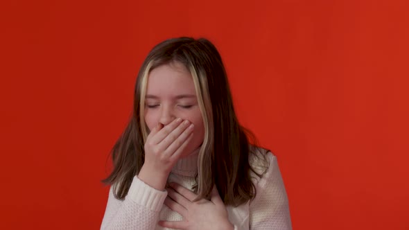 Little Girl Coughs Isolated on Red Background in Studio