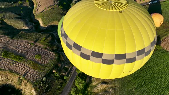 4K Aerial view of Goreme. Colorful hot air balloons fly over the valleys.