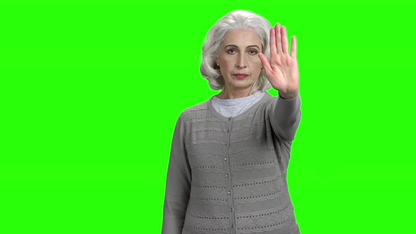 Senior Woman Making Gesture STOP with Hand