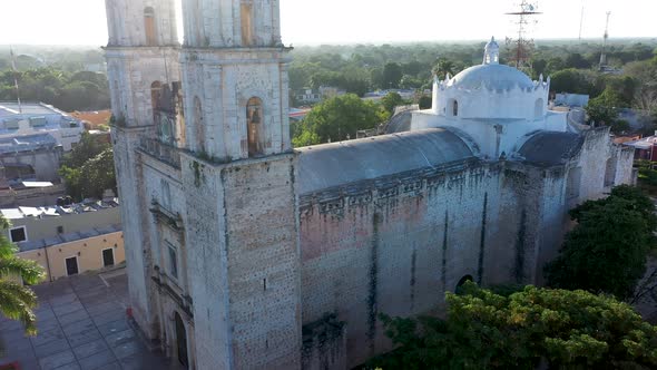 Aerial closeup boom up with sun behind of the Cathedral de San Gervasio just after sunrise in Vallad