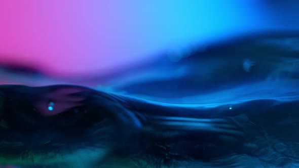 Super Slow Motion Abstract Shot of Swirling Neon Water at 1000Fps