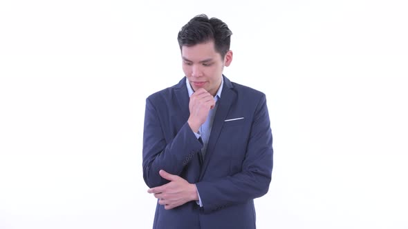 Stressed Young Asian Businessman Thinking and Looking Down