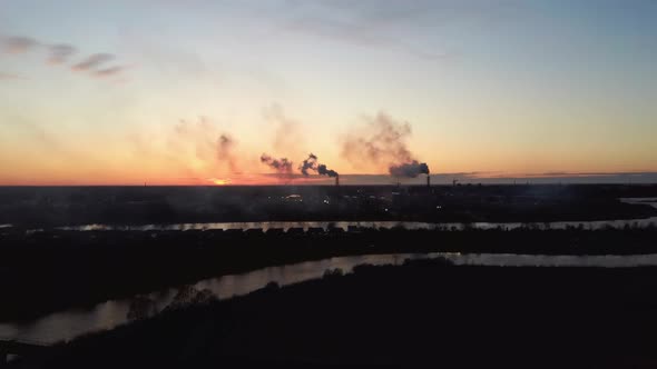  Smoking Stack in Sunrise. Air Pollution and Climate Change Theme. Poor Environment in the City