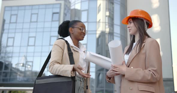 Female Architects Talking About Project at Glass Building