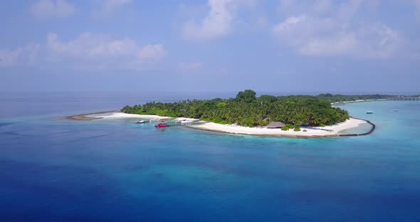Wide angle birds eye island view of a white sand paradise beach and aqua turquoise water background 