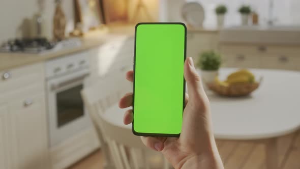 Point of View of Man Holding Chroma Key Green Screen Smartphone Watching Content Without Touching or