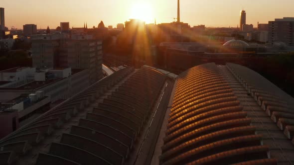 AERIAL: Flight Over Berlin, Germany Ostbahnhof Central Train Station at Beautiful Sunset, Sunlight