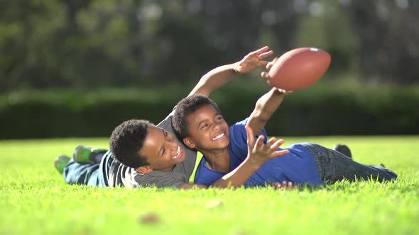 Group portrait of a father and his sons with a football.
