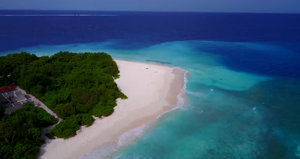 Beautiful birds eye travel shot of a white paradise beach and aqua turquoise water background in 4K