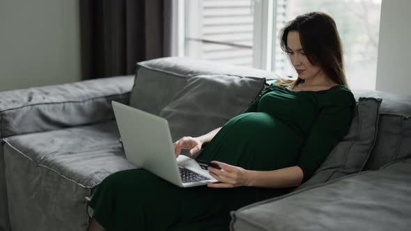 Pregnant Woman Using Credit Card Shopping Online at Home