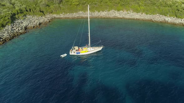 Aerial view of sailboat anchored in the mediterranean sea, Nisi, Greece.