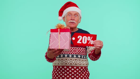 Grandfather in Christmas Sweater Showing Gift Box and 20 Percent Discount Inscriptions Banner Text