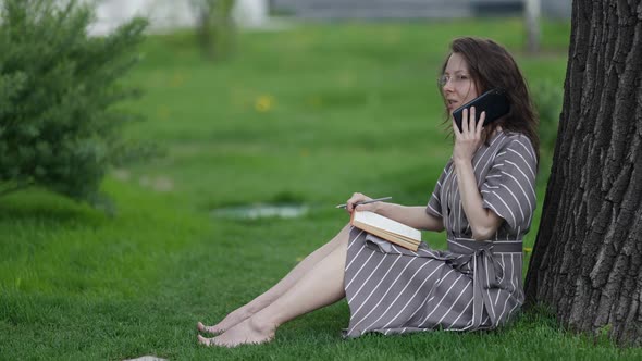 Stay in Touch at Holiday or Vacation Woman is Answering on Mobile Call When Rest in Park