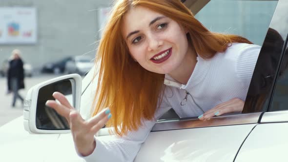 Closeup Portrait of Pissed Off Displeased Angry Aggressive Woman Driving a Car Backwards Shouting at