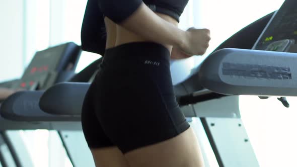 Young Woman Runs on a Treadmill in the Gym, Slow Motion