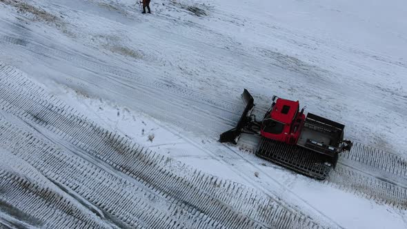 Bulldozer Drives on Road and Cleans Snow in Mountain Area