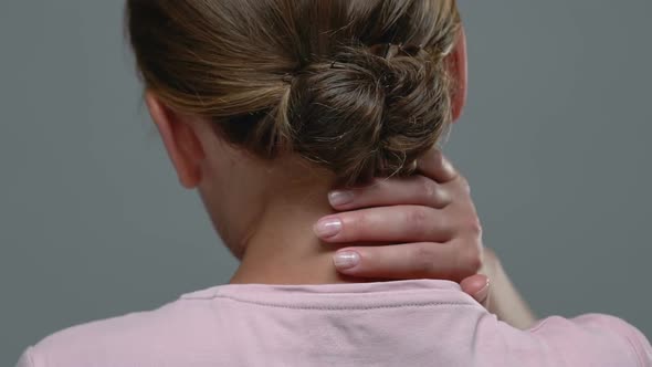 Back View of Woman Massaging Painful Neck, Feeling Strong Ache, Health Problem