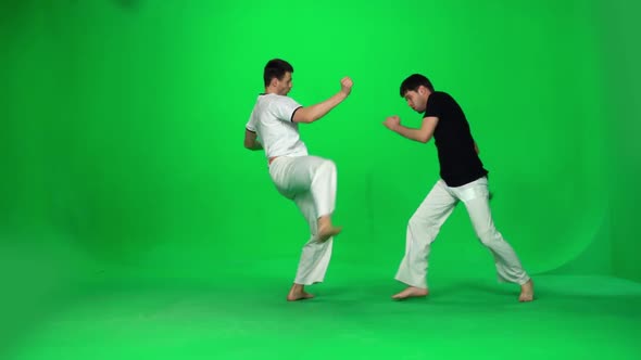 Two Man Are Practicing Capoeira on Chroma Key. Slow Motion.