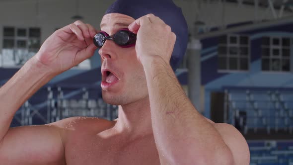 Swimmer putting his pool goggles