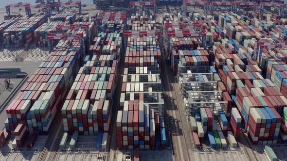 Cargo containers in busy port, aerial. Drone shot. 