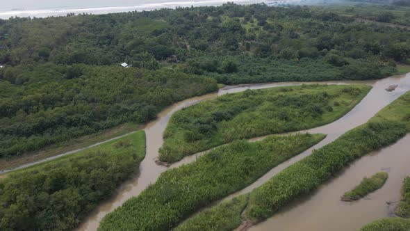 Aerial reveal of the rio cotos river mouth on the central pacific coast of Costa Rica.