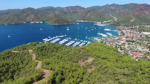 Small City Houses, Beautiful Marina and Touristic Boats in a Cove Surrounded by Forest by Sea