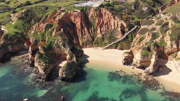 Camilo Beach encircled by steep sandstone cliffs in Lagos, Algarve, Portugal