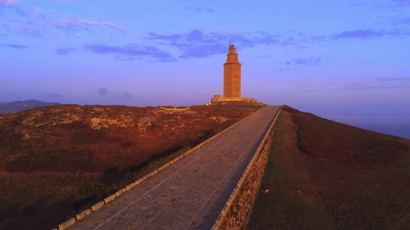 Ancient tower in city outskirts at sunset