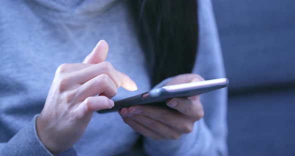 Woman Sending Sms on Cellphone in The Evening at Night