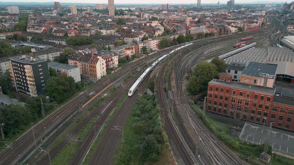 High-Speed ICE train departing the Cologne train station to Düsseldorf in a descend camera Drone fli