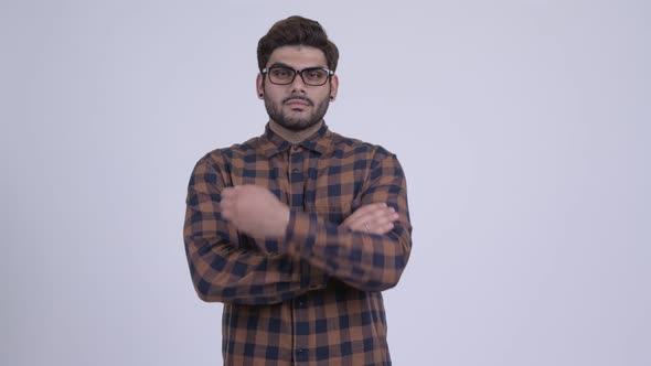Happy Young Bearded Indian Hipster Man with Arms Crossed