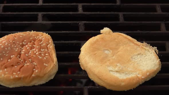 Kitchen Tongs are Putting Fresh Buns for Burgers on the Grill