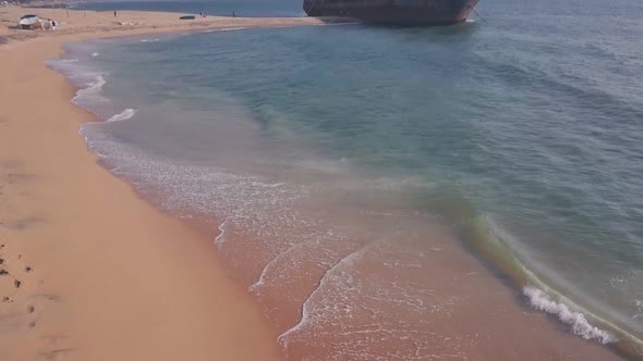 Old shipwreck on a beach near Varkala in Kerala, India. Aerial drone reveal