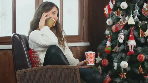 Girl Talking on the Phone While Sitting in a Chair