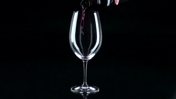 Glass in Which the Sommelier Pouring Red Wine, Black, Silhouette, Slowmotion, Closeup