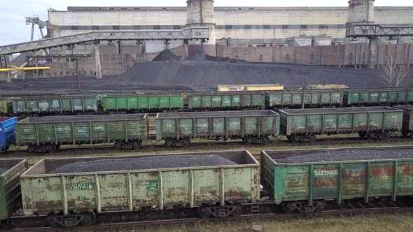 Long Row of Train Cargo Cars Loaded Full with Fossil Fuel Coal