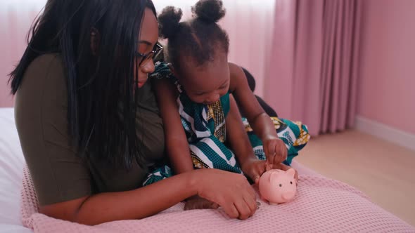 Side view African American mother teach her daughter or little girl to collect money