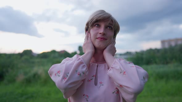 Charming Transgender Woman Dreaming Admiring Nature Outdoors Smiling Looking at Camera