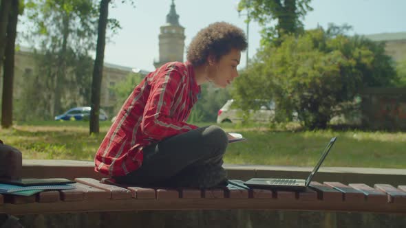 Smart Lovely African American Female Student with Laptop Studying at Campus