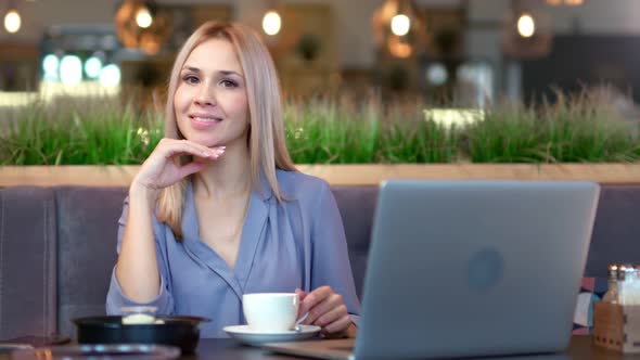 Medium Shot Portrait of Young Pretty Woman Having Good Time Enjoying Break Sitting at Table in Cafe