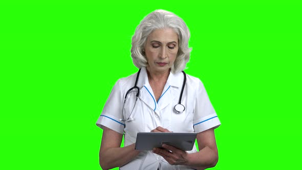 Confident Woman Doctor Using Digital Tablet