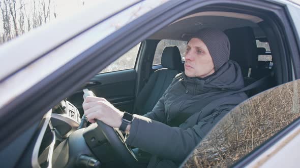 Man Driving a Car in Winter